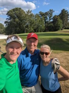 Brendan Dooley with Chris and Holly Dooley at Barker Lake Golf Course on a sunny day in Winter, WI.