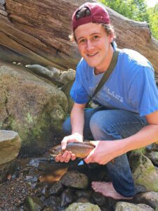 Brendan Dooley holding a brook trout he caught in the Monongahela National Forest in West Virgina.