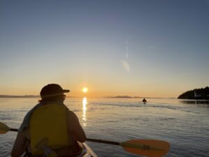 Brendan Dooley sea kayaking off of San Juan Island, Washington during a sunset.