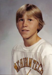 Chris Dooley 8th grade school photo in Eau Claire Wisconsin wearing white shirt.