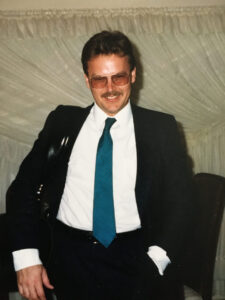 Young Don Finley in a suit and blue tie with his brief case.