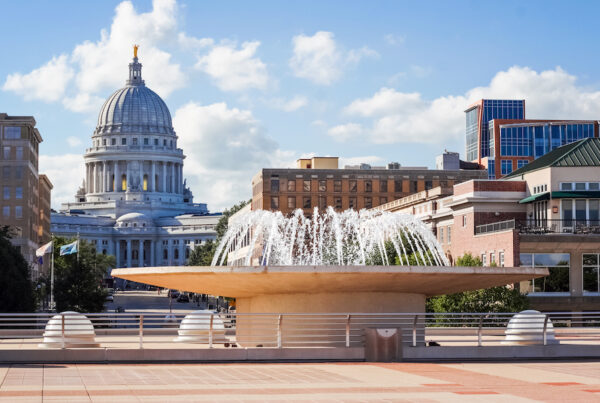 The Monona Terrace water fountain in Madison, Wisconsin with the capitol building in the background.