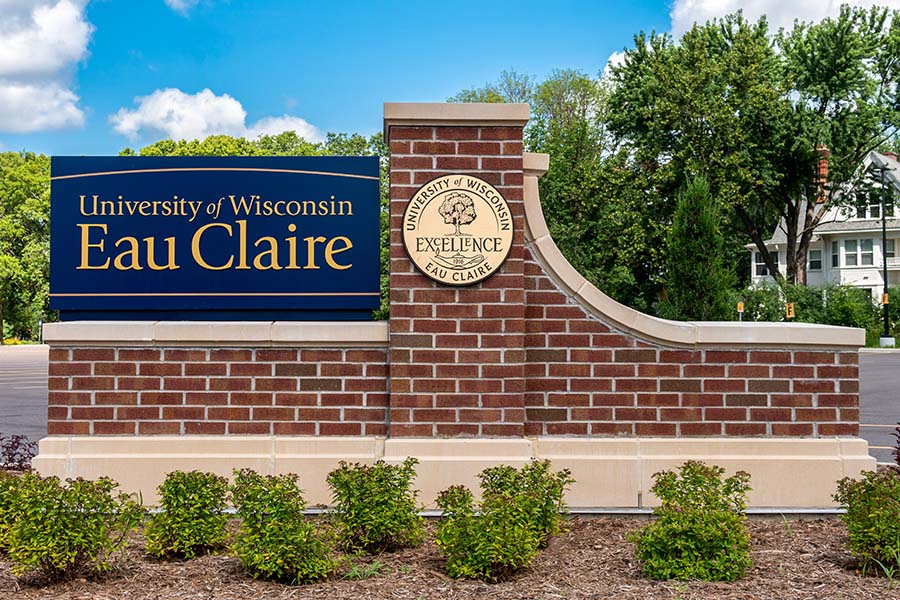 University of Wisconsin Eau Claire crossing bridge river entrance sign and the university bronze seal.