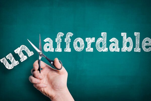 Changing commercial auto insurance from unaffordable to affordable on a white chalkboard.