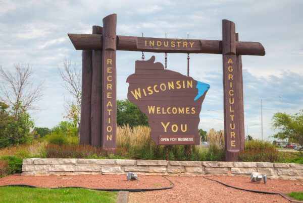 Wisconsin business and industry brown wooden highway welcome sign.