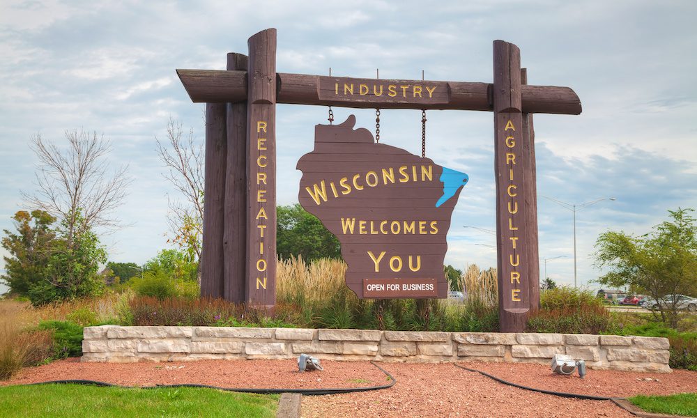 Wisconsin business and industry brown wooden highway welcome sign.