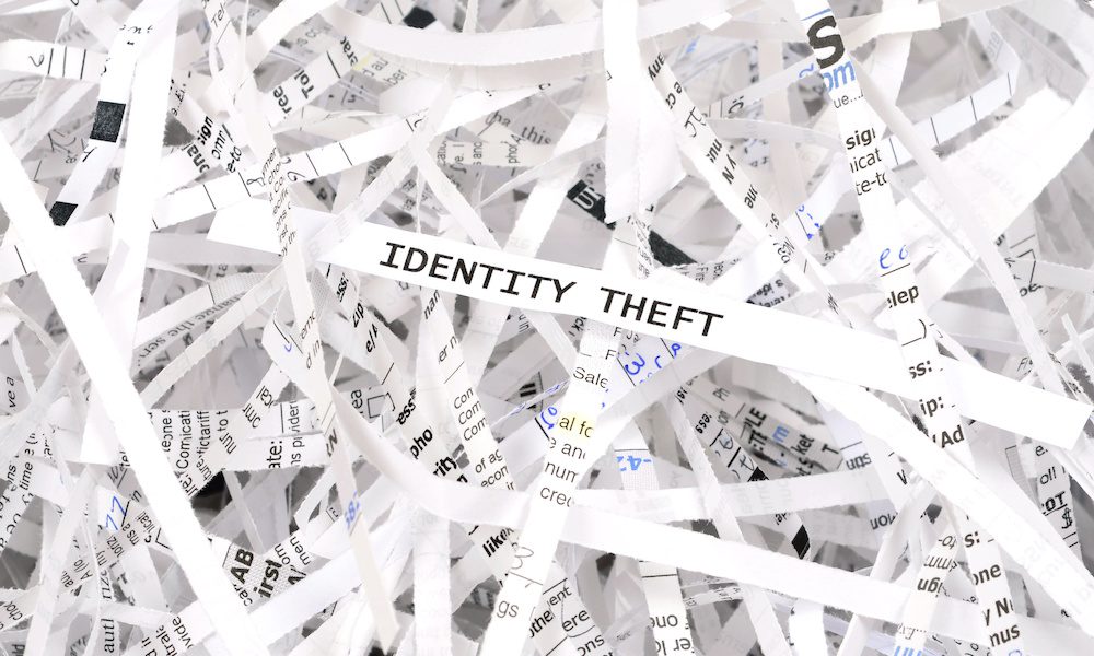 Identity theft written on shredded piece of white paper.