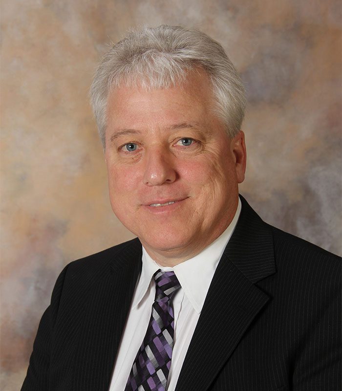 Professional photo of Medicare supplements insurance agent Mario Racanelli in a suit.