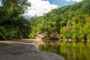 Sugar creek running along the bluffs on a sunny day in Turkey Run State Park in Indiana.