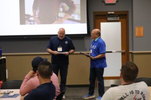 MSIG Employee Benefits agent, Wally Wheeler, receiving the Mover & Shaker Award for Leadership Eau Claire Class of 2024 from Phil Swiler of Valley Sports Academy.